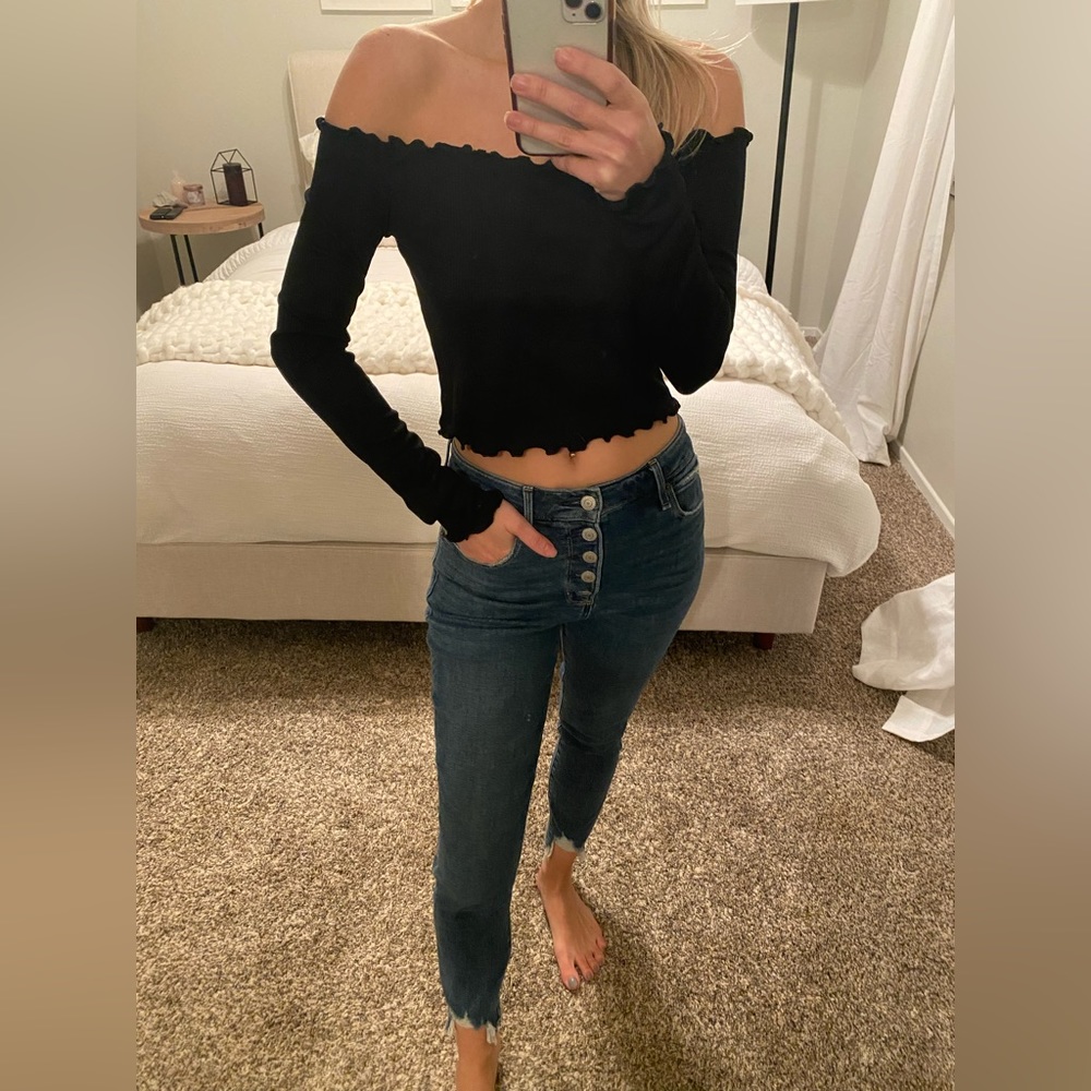 Black long sleeve off the shoulder top with ruffled edge detail